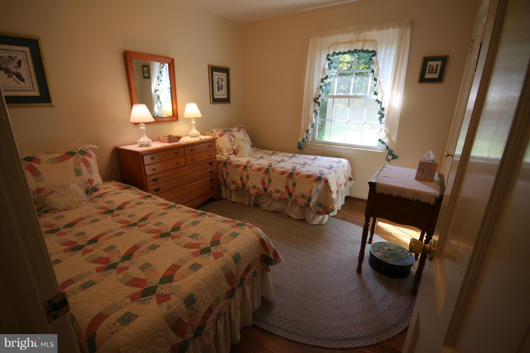 14014 Notley Road Silver Spring, MD 20904 - Photo 20 of 30 a bedroom with two beds and a window