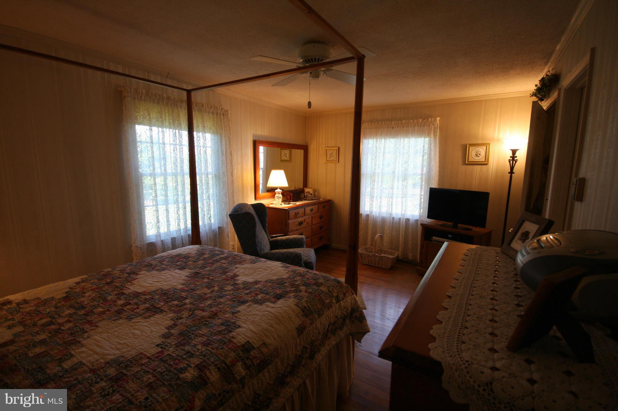 14014 Notley Road Silver Spring, MD 20904 - Photo 21 of 30 a bedroom with a bed lamp on desk and a window