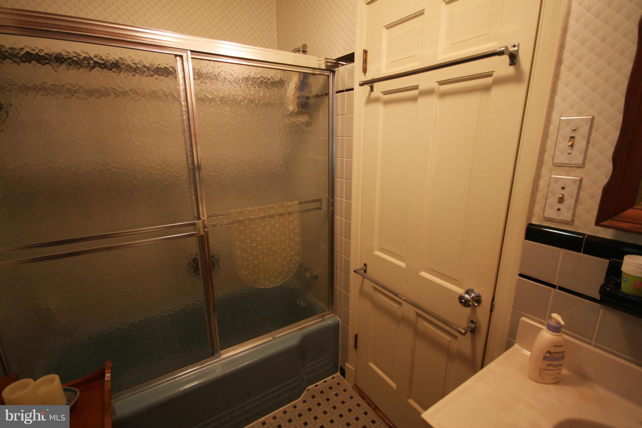 14014 Notley Road Silver Spring, MD 20904 - Photo 24 of 30 a bathroom with a glass shower door