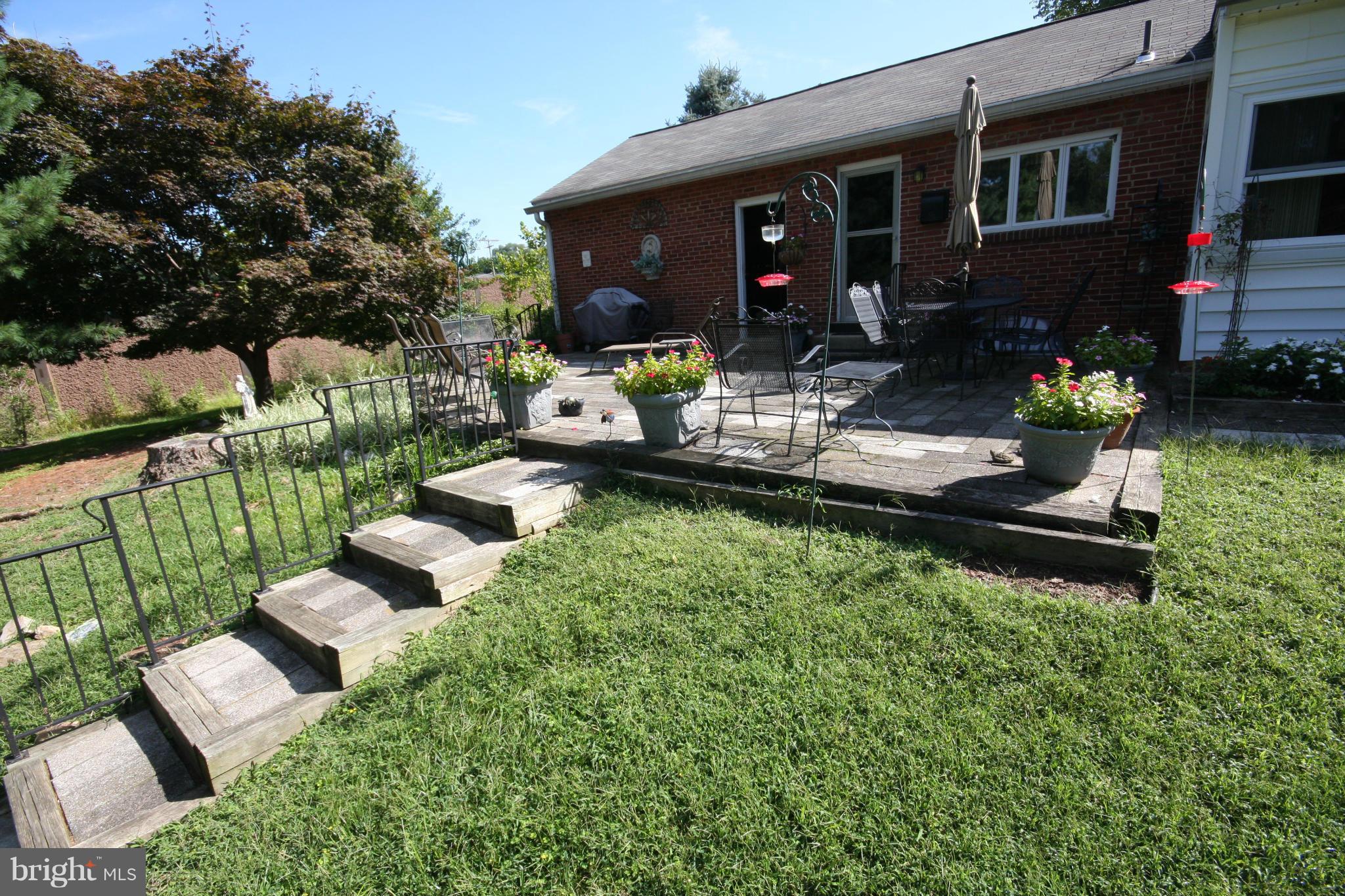 14014 Notley Road Silver Spring, MD 20904 - Photo 6 of 30 a front view of a house with patio furniture and garden