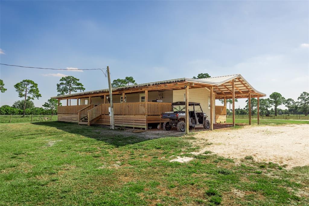 1075 Southwest Rucks Dairy Road Okeechobee, FL 34974 - Photo 26 of 65 a view of a house with a yard