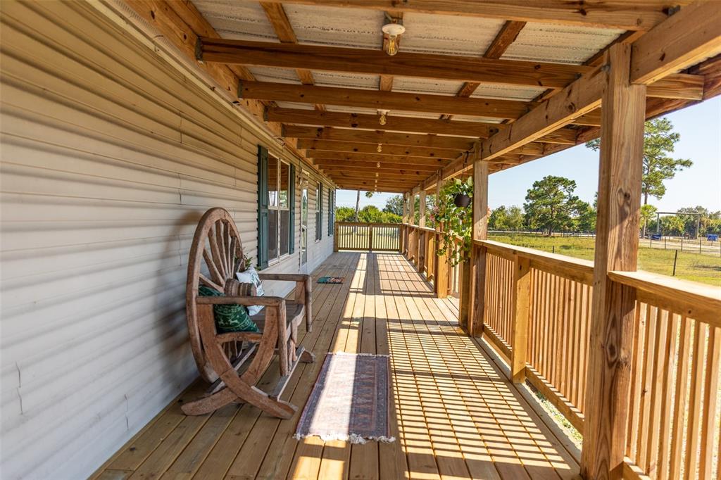 1075 Southwest Rucks Dairy Road Okeechobee, FL 34974 - Photo 30 of 65 a view of a balcony with wooden floor