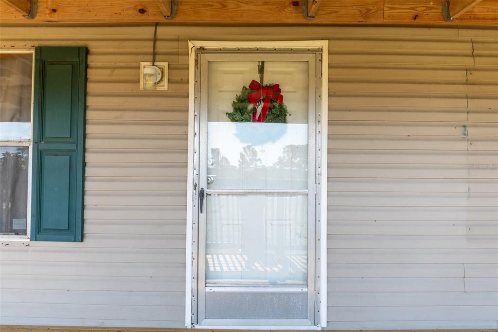 1075 Southwest Rucks Dairy Road Okeechobee, FL 34974 - Photo 32 of 65 a view of a entryway door front of house