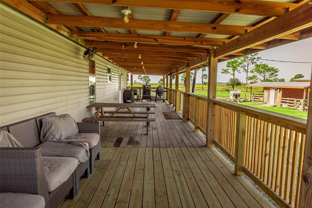 1075 Southwest Rucks Dairy Road Okeechobee, FL 34974 - Photo 34 of 65 a view of a porch with wooden floor