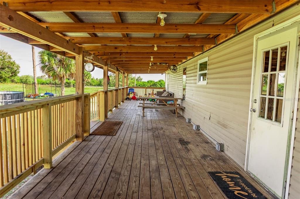 1075 Southwest Rucks Dairy Road Okeechobee, FL 34974 - Photo 35 of 65 a view of porch with wooden floor