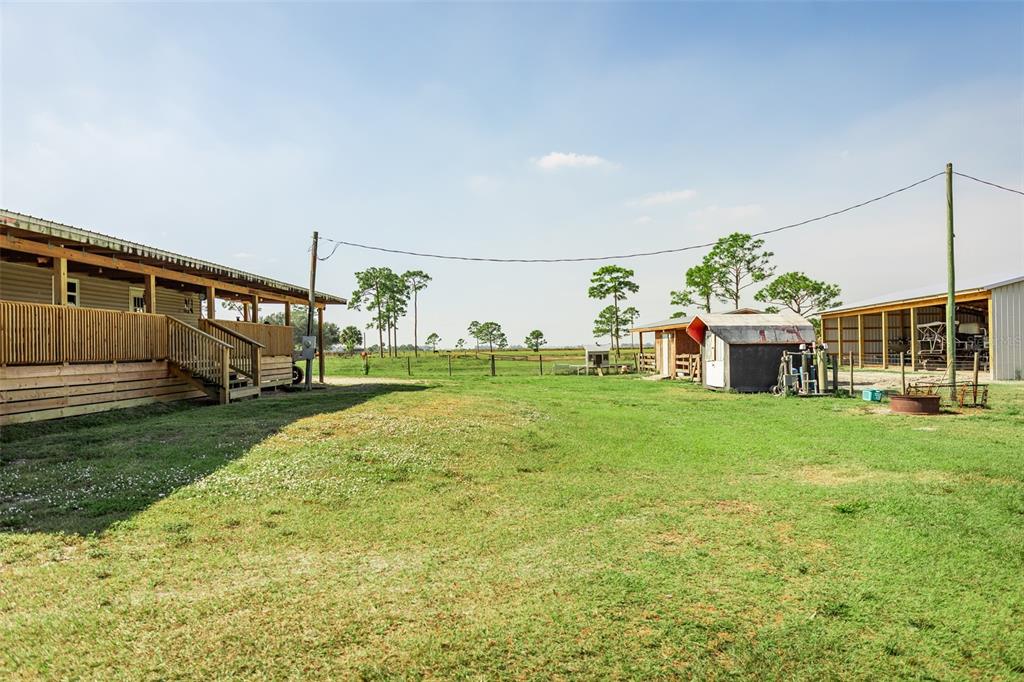 1075 Southwest Rucks Dairy Road Okeechobee, FL 34974 - Photo 37 of 65 a view of a house with backyard and garden