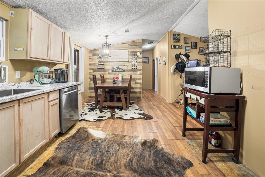 1075 Southwest Rucks Dairy Road Okeechobee, FL 34974 - Photo 45 of 65 a kitchen with stainless steel appliances granite countertop a refrigerator stove and a sink