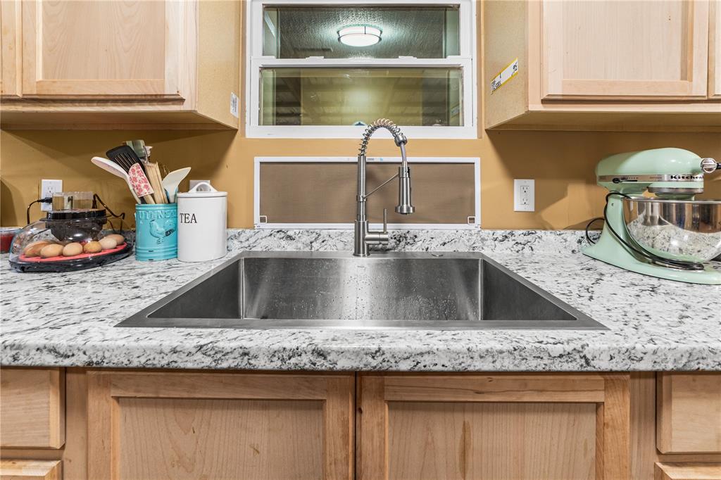 1075 Southwest Rucks Dairy Road Okeechobee, FL 34974 - Photo 46 of 65 a kitchen with granite countertop a sink and a stove