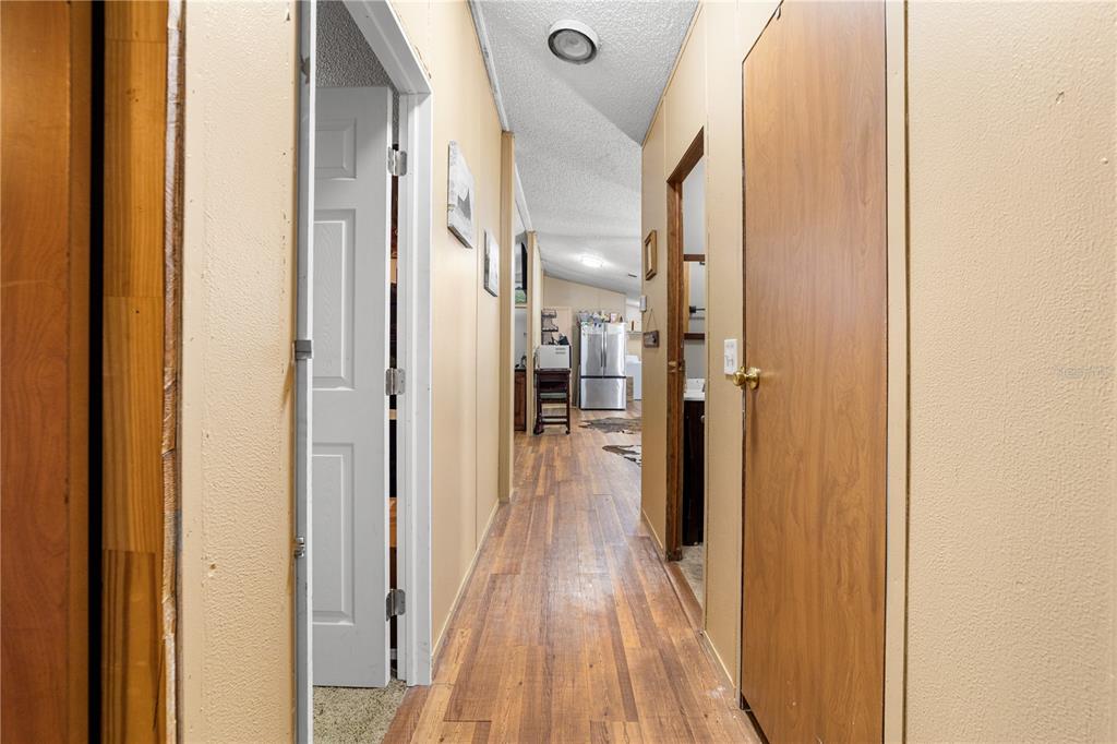 1075 Southwest Rucks Dairy Road Okeechobee, FL 34974 - Photo 54 of 65 a view of a hallway with wooden floor and staircase