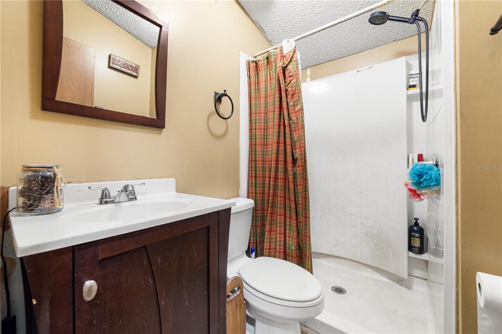 1075 Southwest Rucks Dairy Road Okeechobee, FL 34974 - Photo 55 of 65 a bathroom with a sink vanity mirror and toilet