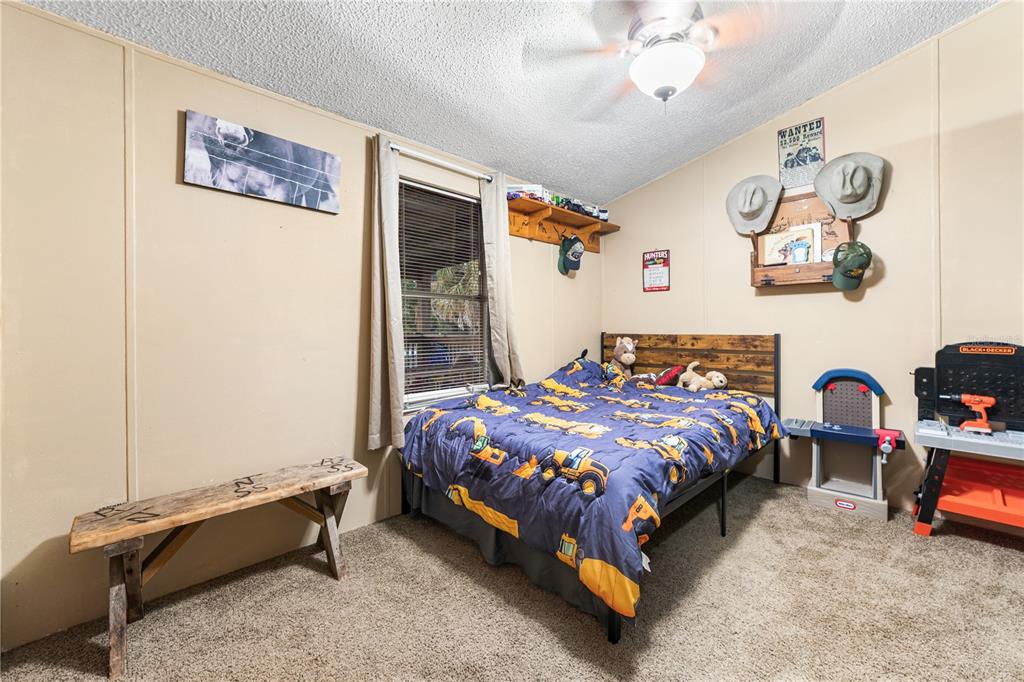 1075 Southwest Rucks Dairy Road Okeechobee, FL 34974 - Photo 56 of 65 a bedroom with a bed and a window