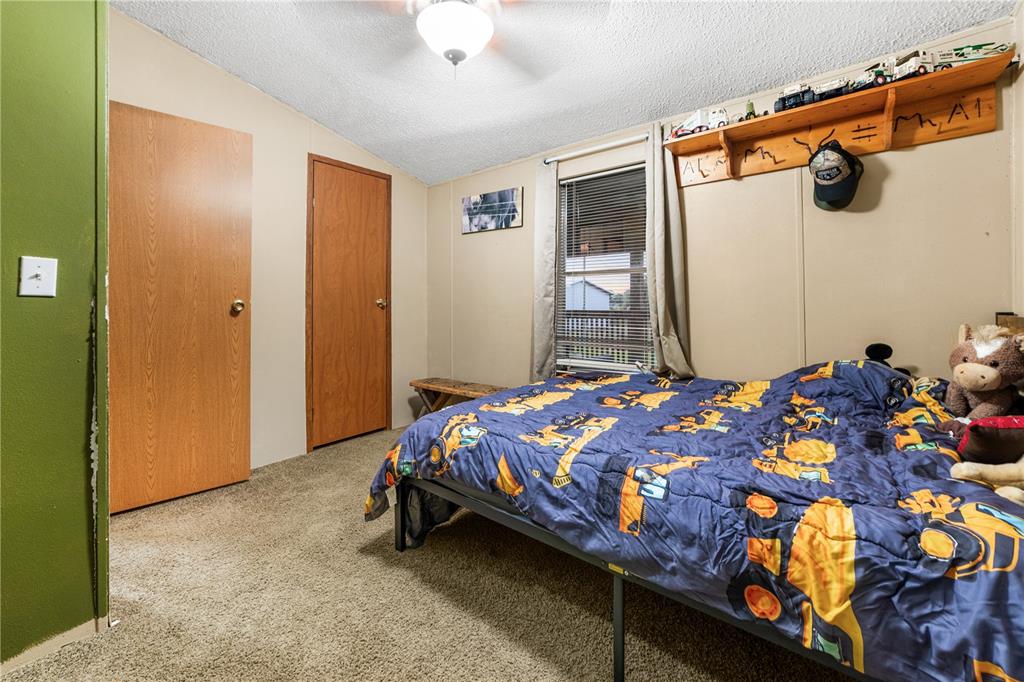 1075 Southwest Rucks Dairy Road Okeechobee, FL 34974 - Photo 58 of 65 a bedroom with a bed and a chandelier