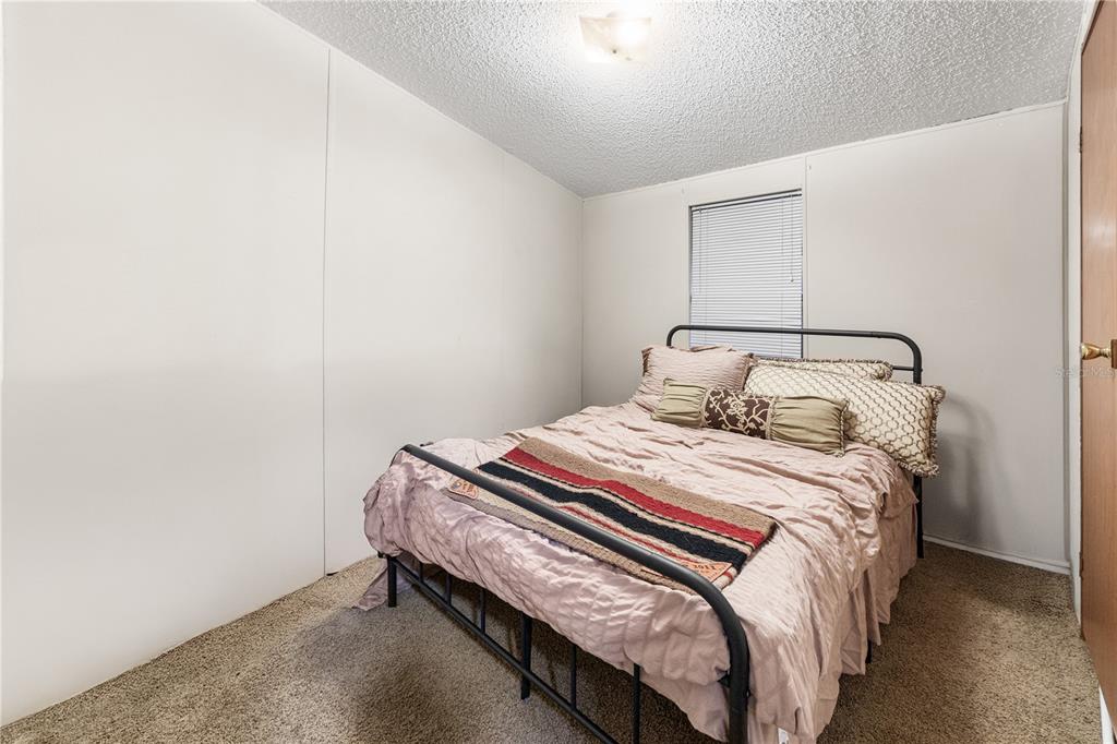 1075 Southwest Rucks Dairy Road Okeechobee, FL 34974 - Photo 59 of 65 a bedroom with a bed and a window