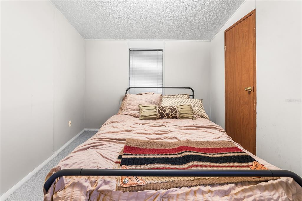 1075 Southwest Rucks Dairy Road Okeechobee, FL 34974 - Photo 60 of 65 a bedroom with a bed and window