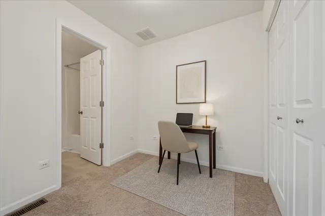 a bathroom with a granite countertop sink a toilet and a mirror