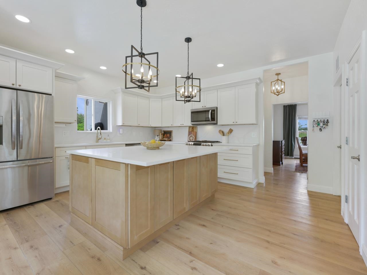2433 H Road Grand Junction, CO 81505 - Photo 14 of 42 a kitchen with kitchen island white cabinets and stainless steel appliances