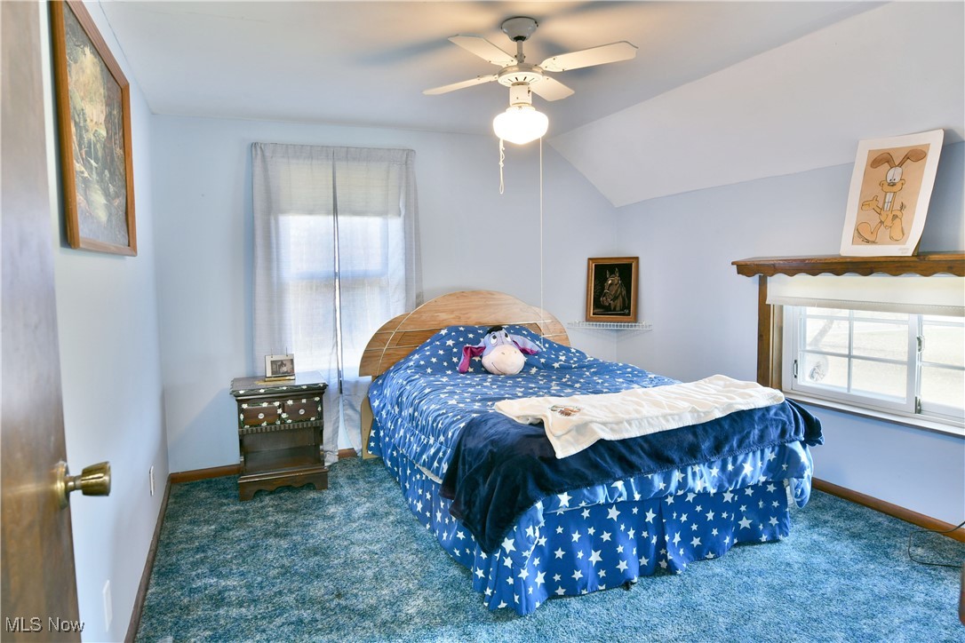 1509 State Road Northwest Warren, OH 44481 - Photo 43 of 49 Carpeted bedroom featuring lofted ceiling and ceiling fan