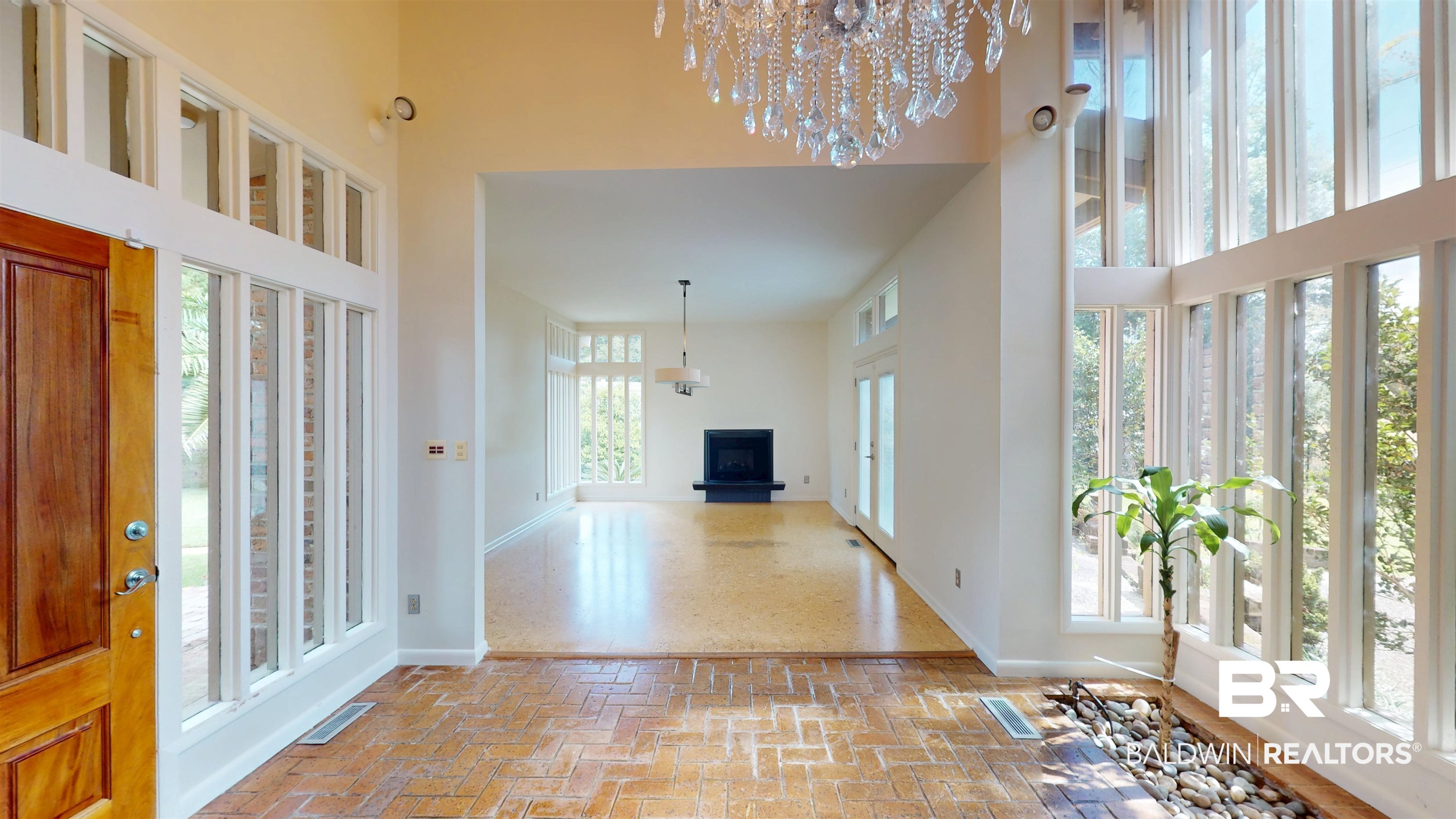 15 Spring Bank Road Mobile, AL 36608 - Photo 7 of 58 Entrance foyer with a chandelier, brick floors, plenty of natural light, and a towering ceiling