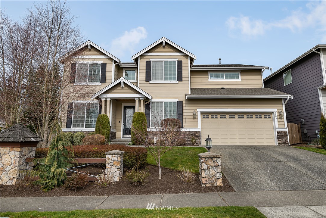 3909 219th Street Southeast Bothell, WA 98021 - Photo 1 of 34 a front view of a house with a yard and garage