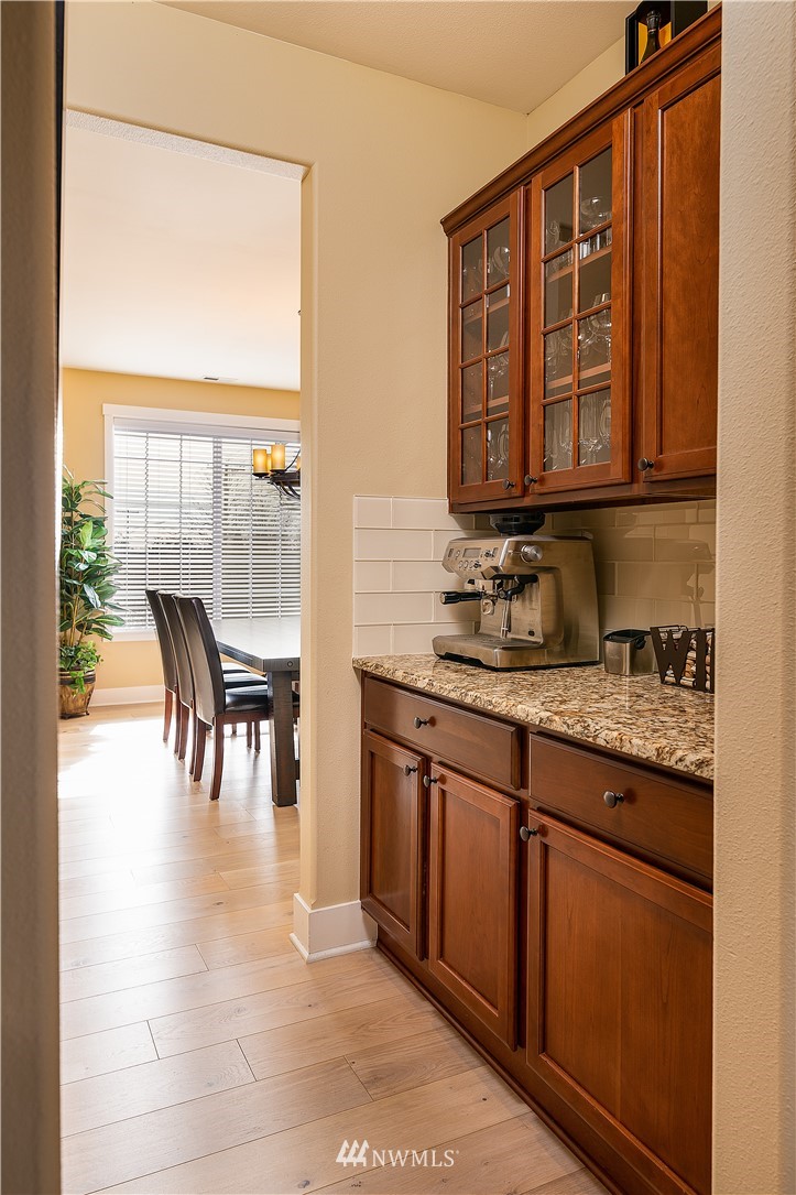 3909 219th Street Southeast Bothell, WA 98021 - Photo 11 of 34 a kitchen with granite countertop a stove a sink and a dining table next to a window