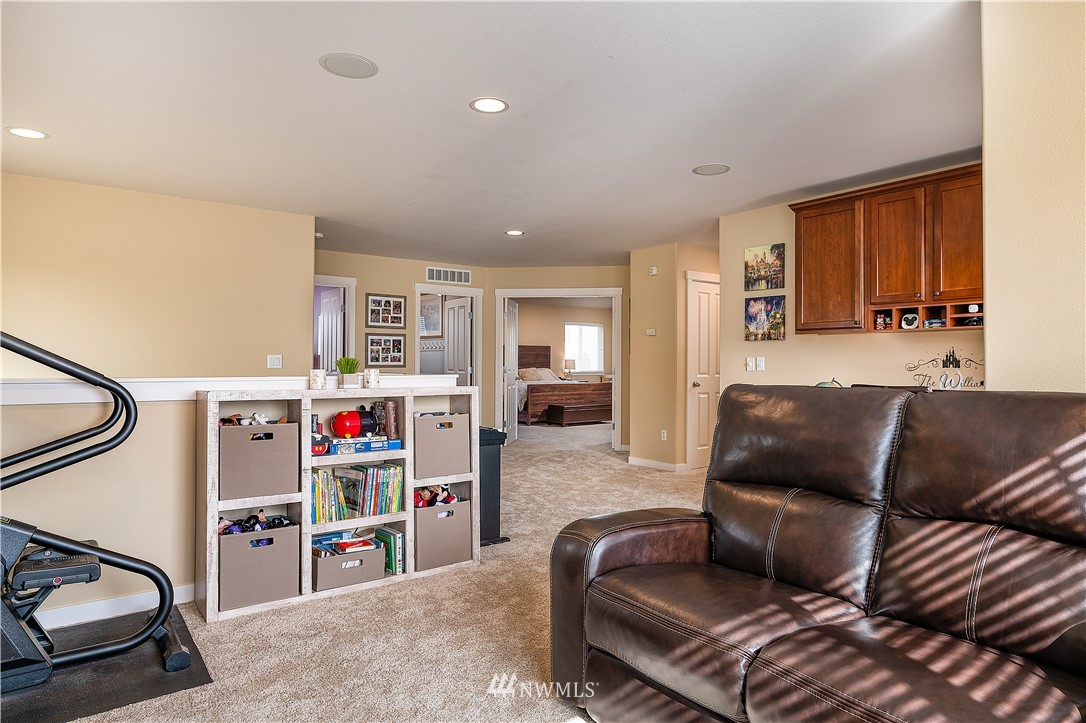 3909 219th Street Southeast Bothell, WA 98021 - Photo 16 of 34 a living room with furniture and a flat screen tv