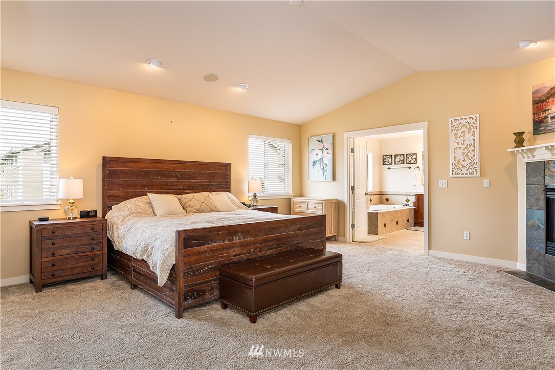 3909 219th Street Southeast Bothell, WA 98021 - Photo 17 of 34 a bed sitting in a spacious bedroom next to a window and a larger closet