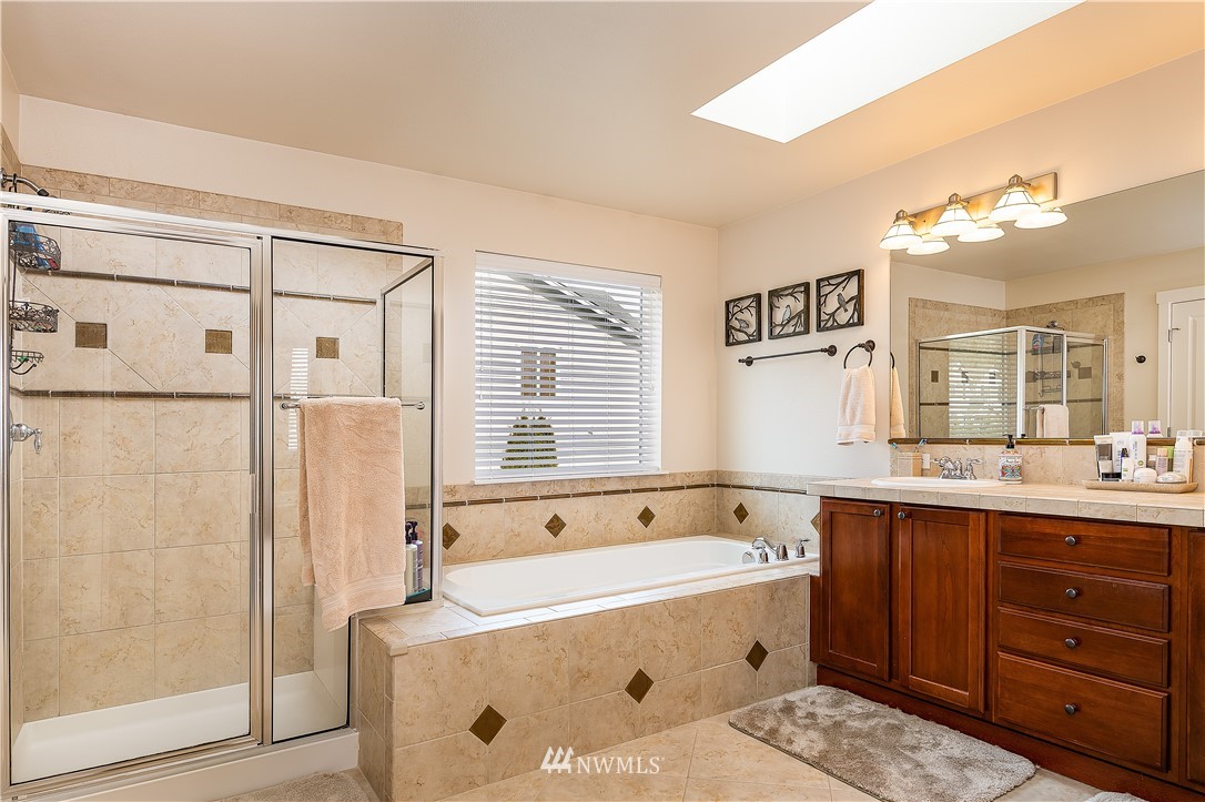 3909 219th Street Southeast Bothell, WA 98021 - Photo 19 of 34 a spacious bathroom with a tub sink and shower