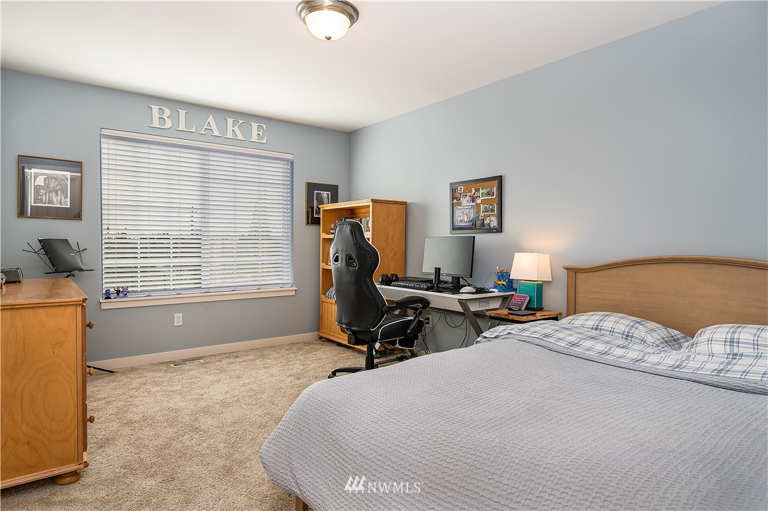 3909 219th Street Southeast Bothell, WA 98021 - Photo 22 of 34 a bedroom with a bed and a window