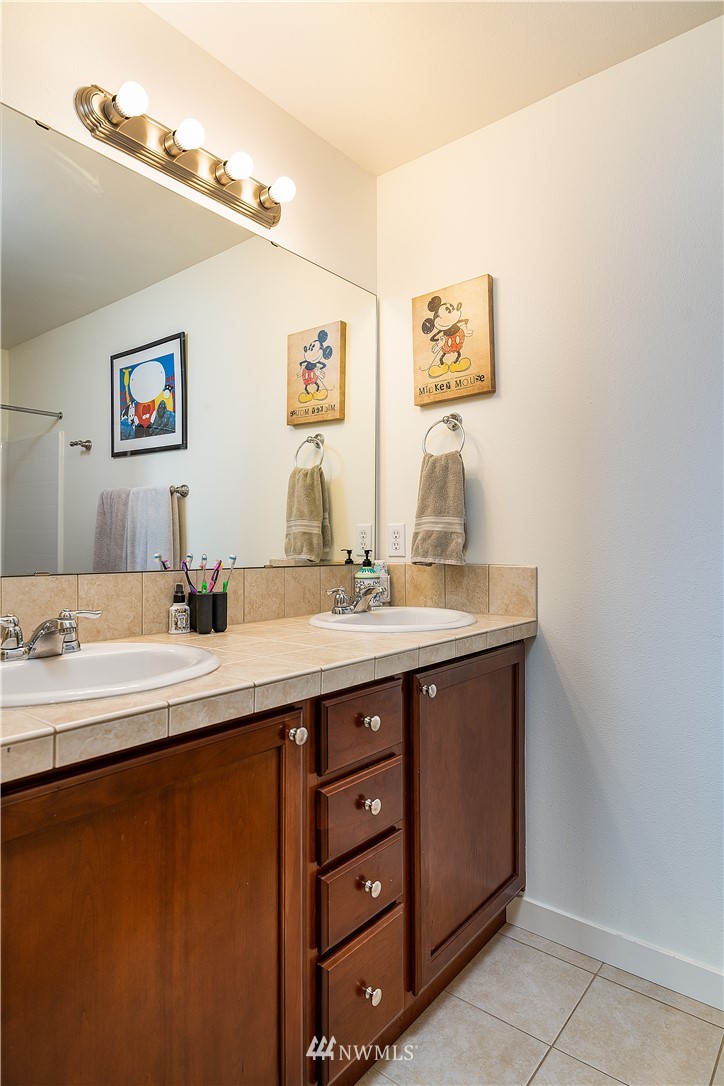 3909 219th Street Southeast Bothell, WA 98021 - Photo 24 of 34 a bathroom with a double vanity sink and a mirror