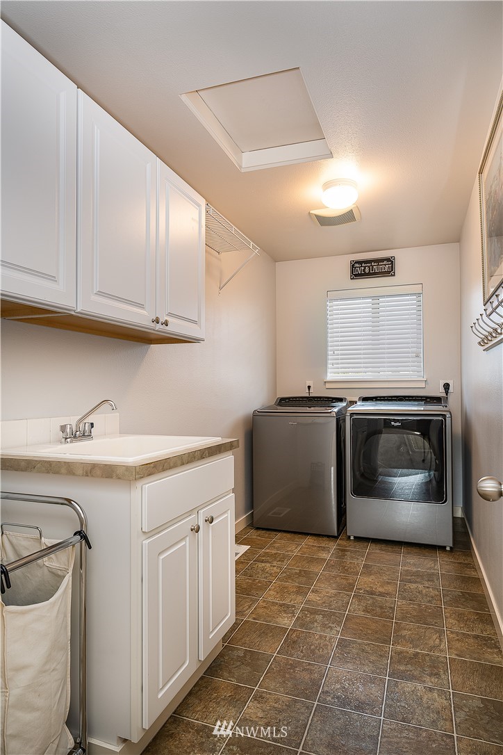 3909 219th Street Southeast Bothell, WA 98021 - Photo 25 of 34 a kitchen with a stove top oven and cabinets