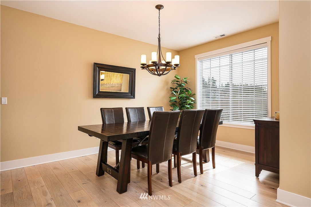 3909 219th Street Southeast Bothell, WA 98021 - Photo 8 of 34 a view of a dining room with furniture window and wooden floor