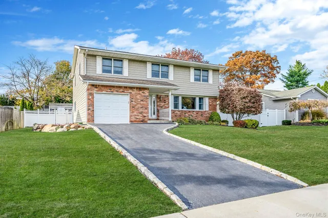 a front view of a house with a garden and yard