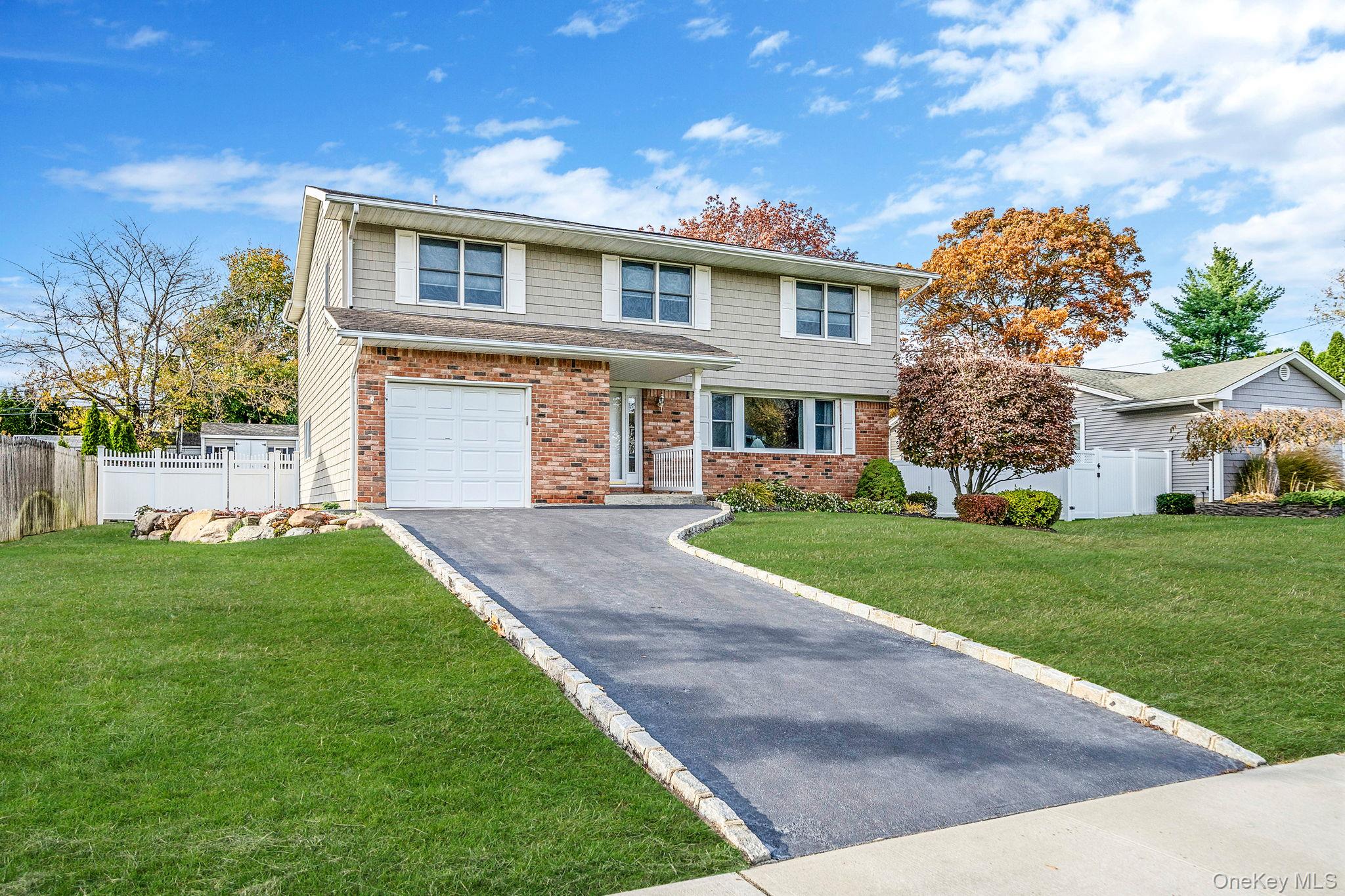 a front view of a house with a garden and yard