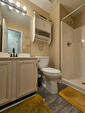 a bathroom with a sink toilet and shower