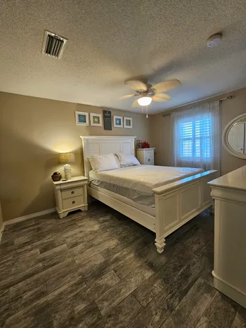 a bedroom with a bed and a night stand