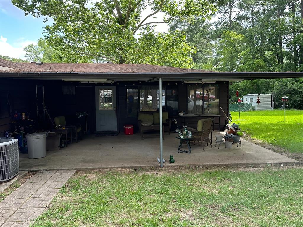 6371 Buncombe Road Shreveport, LA 71129 - Photo 6 of 17 a view of a chair and table in backyard of the house