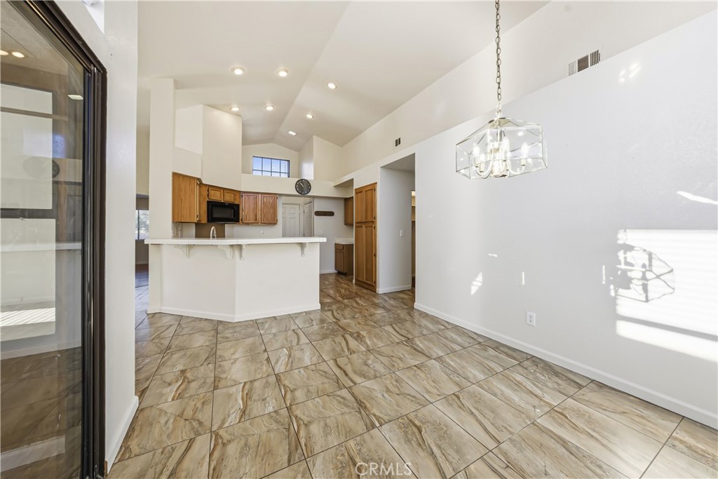483 Violet Avenue Nipomo, CA 93444 - Photo 12 of 47 a view of a kitchen with center island and stainless steel appliances