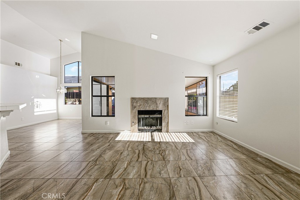 483 Violet Avenue Nipomo, CA 93444 - Photo 15 of 47 a view of a livingroom with a fireplace a fireplace and windows