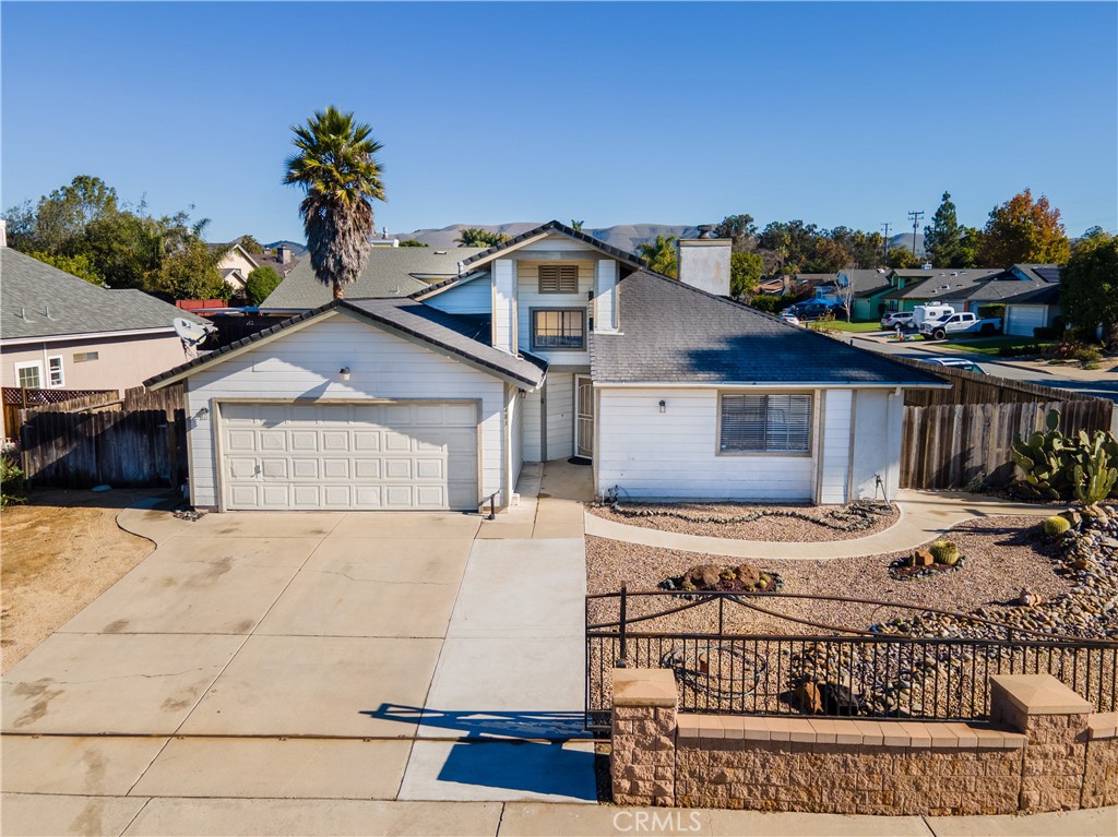 483 Violet Avenue Nipomo, CA 93444 - Photo 2 of 47 a view of a house with a yard