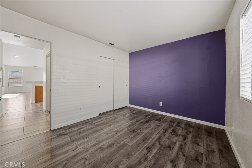 483 Violet Avenue Nipomo, CA 93444 - Photo 24 of 47 an empty room with wooden floor and windows