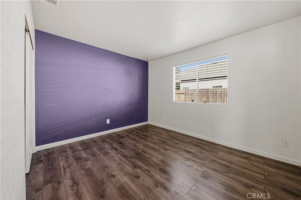 483 Violet Avenue Nipomo, CA 93444 - Photo 25 of 47 an empty room with wooden floor and windows