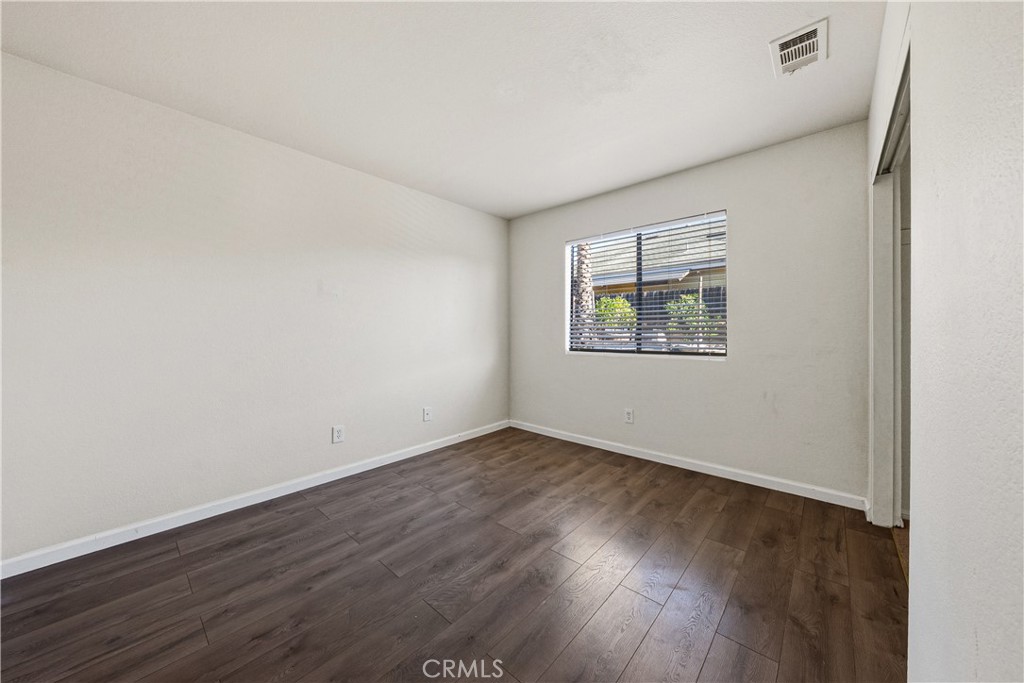 483 Violet Avenue Nipomo, CA 93444 - Photo 28 of 47 an empty room with wooden floor and windows