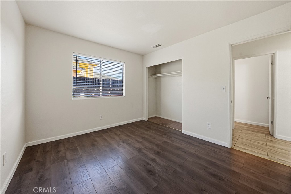 483 Violet Avenue Nipomo, CA 93444 - Photo 29 of 47 an empty room with wooden floor and windows