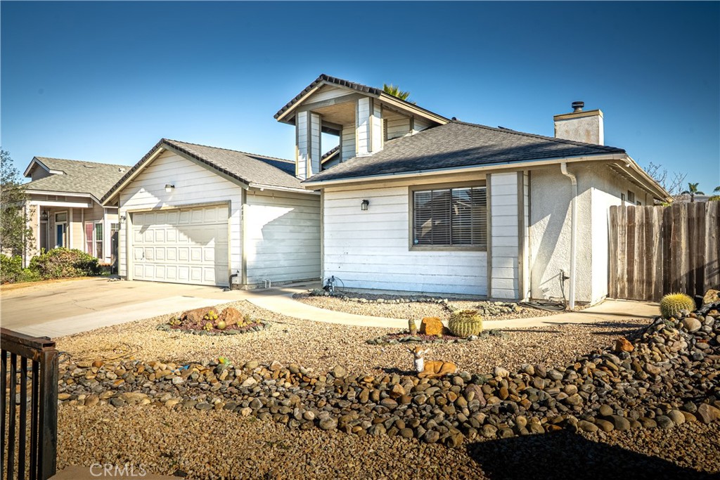 483 Violet Avenue Nipomo, CA 93444 - Photo 4 of 47 a front view of a house with a yard