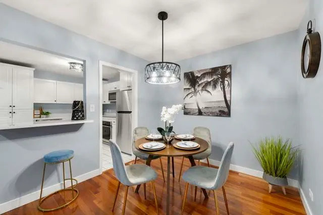 a view of a dining room with furniture wooden floor and a chandelier