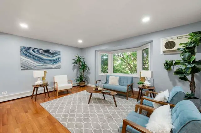 a living room with furniture and a large window