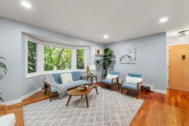 a living room with furniture and a large window