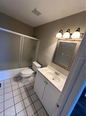 a bathroom with a sink mirror and toilet