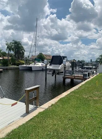 a view of a lake with boats and tables in the background