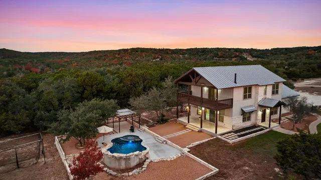 an aerial view of a house with a yard and balcony